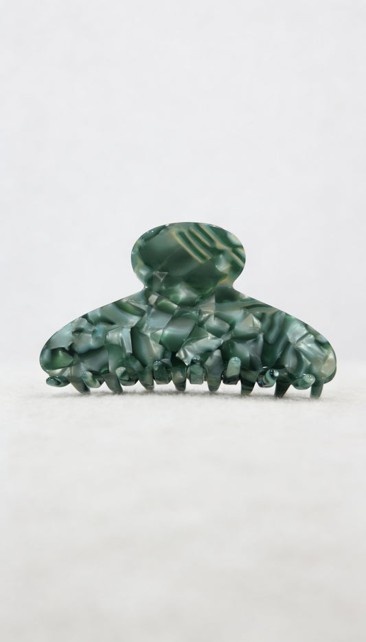 Green marbled hair clip on a white background